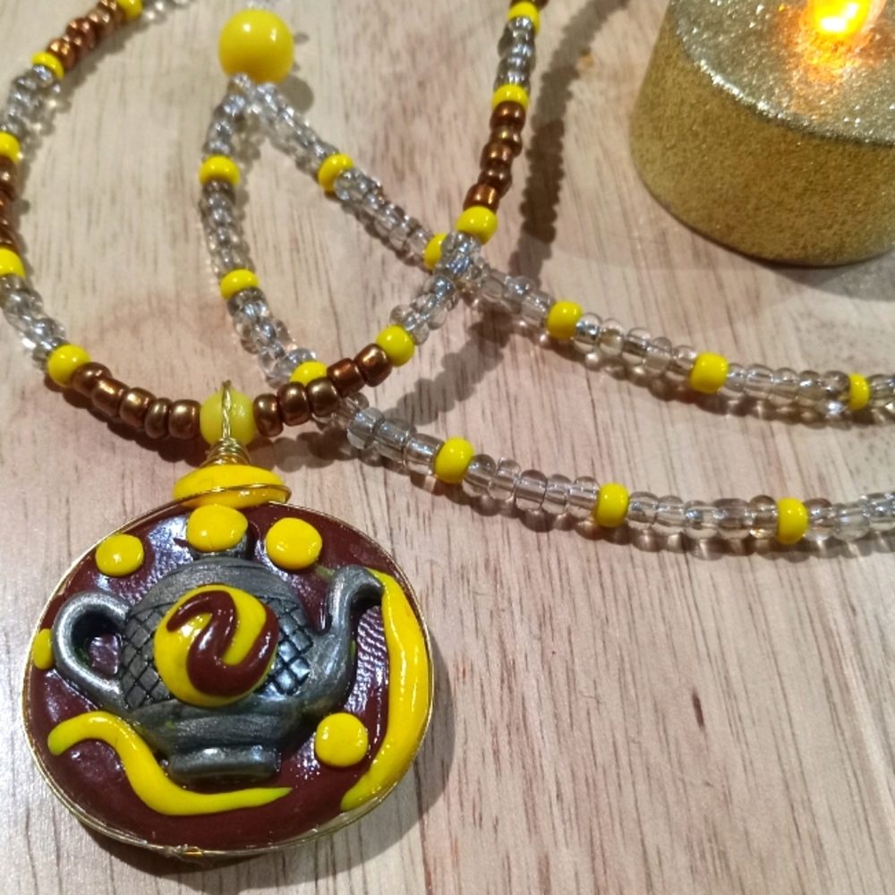 Magical Teapot Talisman in Brown and yellow emblem necklace